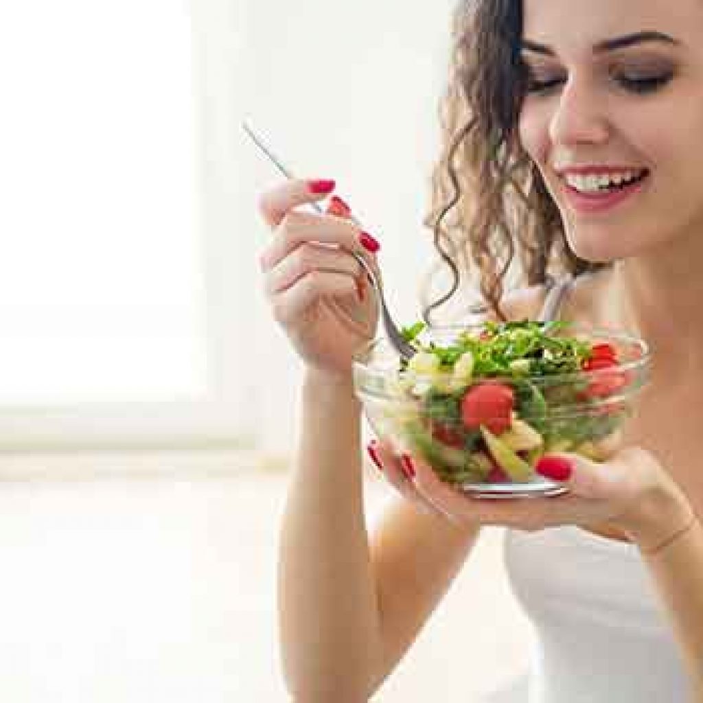 A girl eating a healthy salad