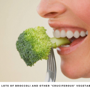 Woman eating a broccoli